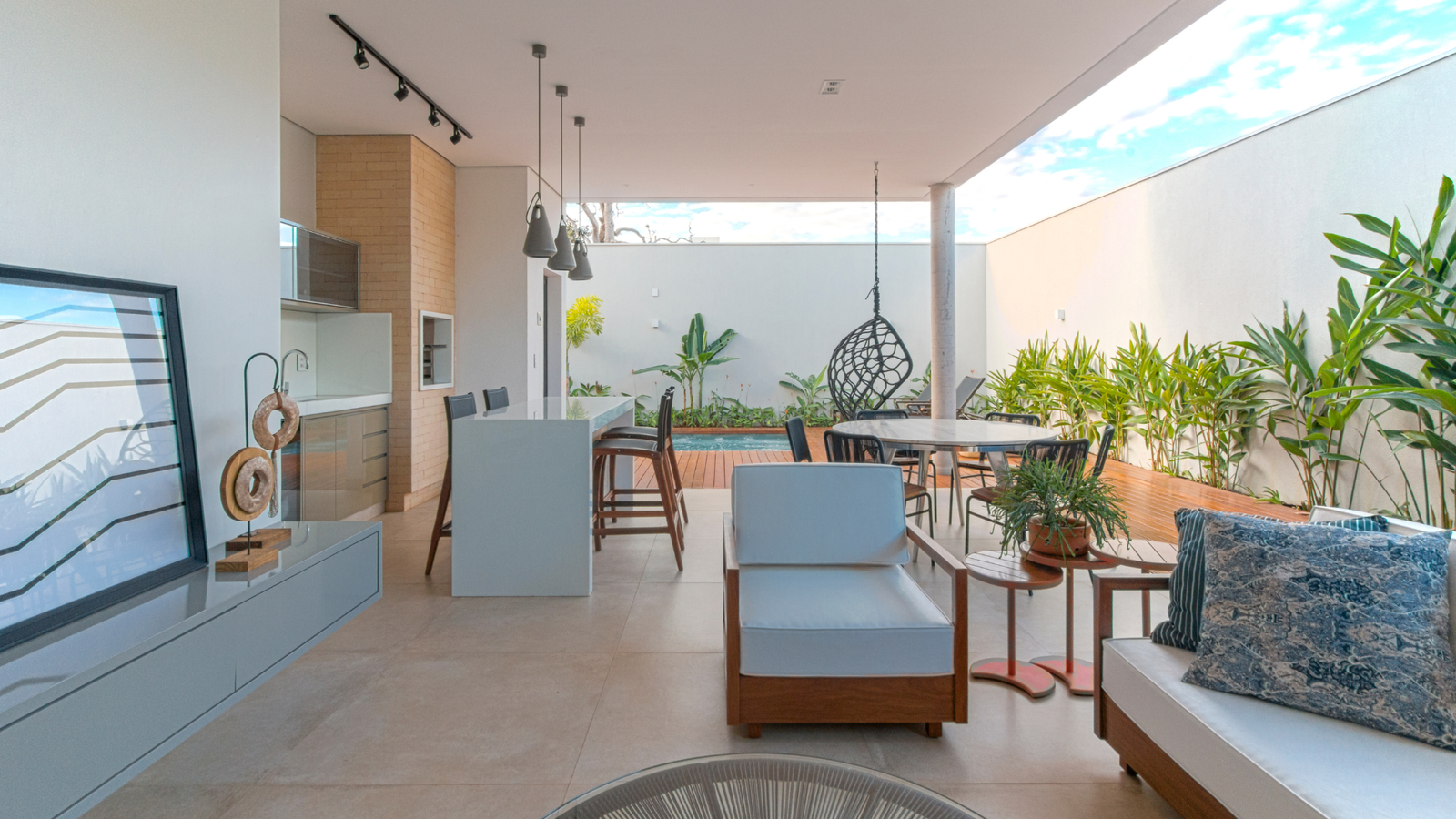 outdoor patio with chair, a hanging chair and dining area in California.