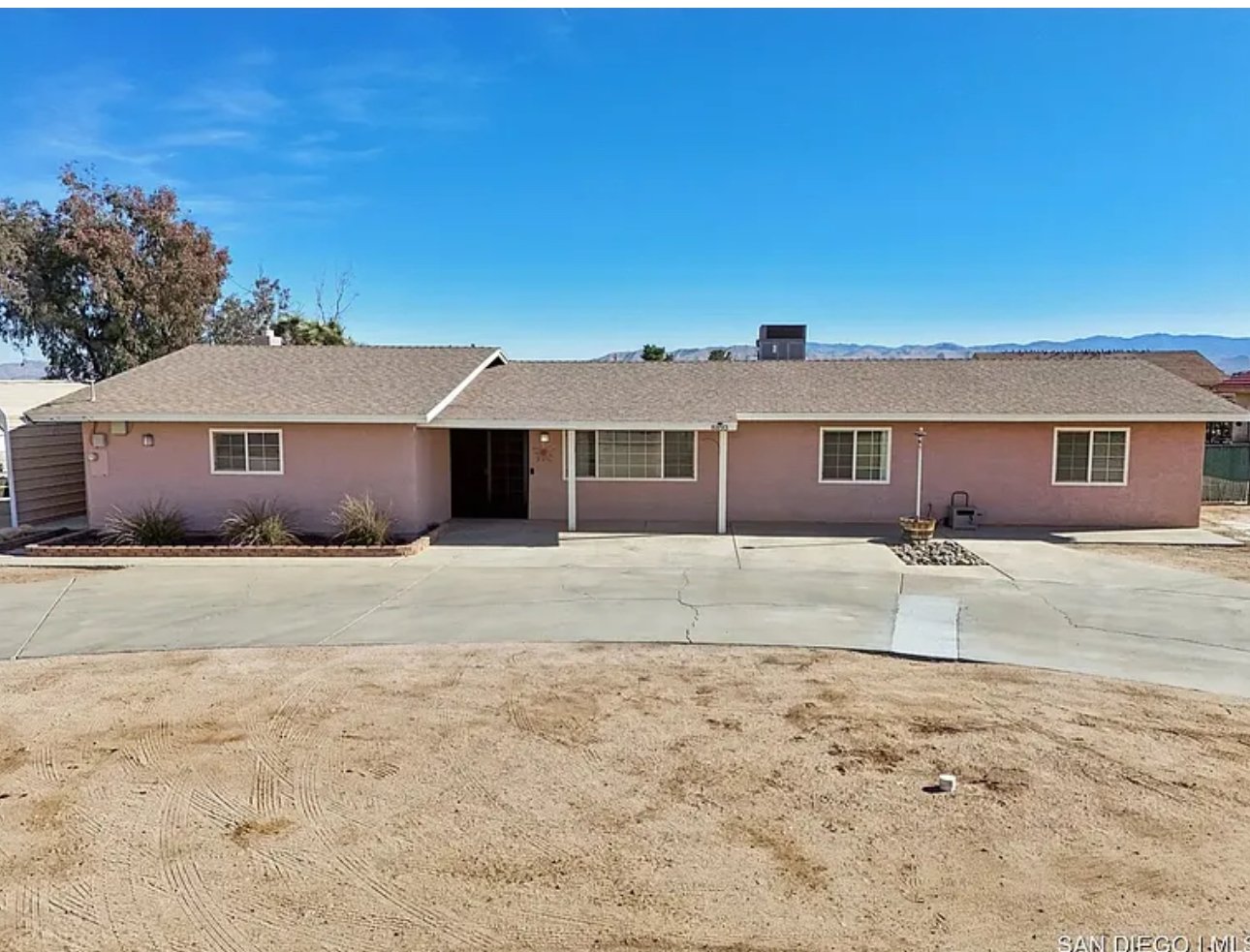 Single-story, light pink house with a covered porch in Hesperia